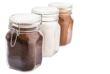 Instant coffee, chocolate drink powder and sugar in glass jar 