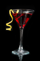 Red alcohol cosmopolitan cocktail decorated with citrus lemon tw