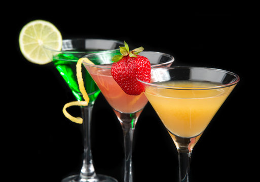 Three cocktails cosmopolitan cocktails decorated with citrus lem