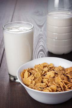 glass of milk and bowl of cornflakes