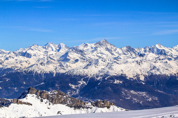 Fototapeta na wymiar Alpine landscape with peaks covered by snow