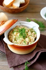 wheat porridge in a pot with greens