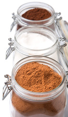 Instant coffee, chocolate drink powder and sugar in glass jar 