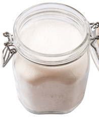 Granulated sugar in glass jar container 
