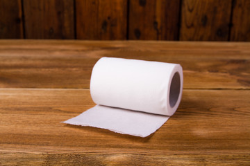 white toilet paper on a wooden table