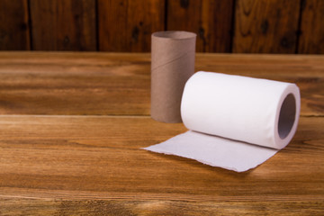white toilet paper on a wooden table