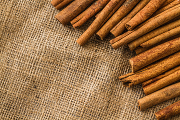 Cinnamon Sticks on Burlap Tablecloth Background