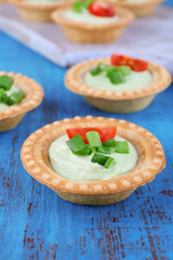 Tartlets with greens and vegetables with sauce