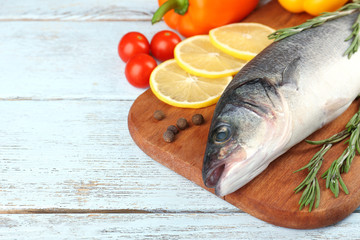 Fresh raw fish and food ingredients on table