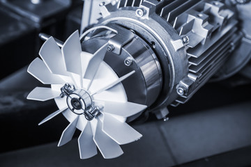 Modern electric motor fragment, blue toned photo