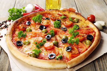 Tasty pizza with sausage, vegetables and chili pepper