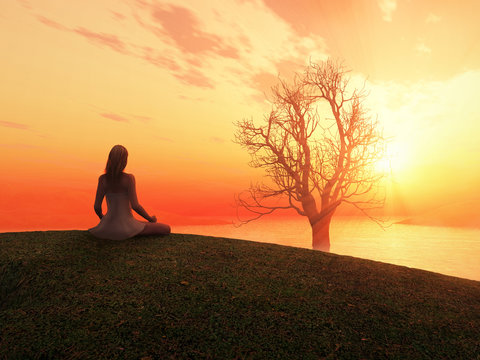 woman meditating at sunrise