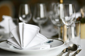 Plate and wine glasses set up at restaurant, cutlery