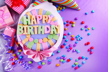 Delicious birthday cake on table close-up