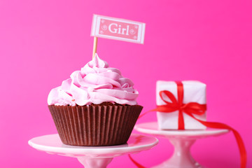 Delicious cupcake with inscription on pink background