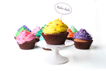 Delicious cupcakes with inscription isolated on white