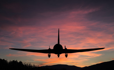 Fototapeta na wymiar Flying airplane silhouette.