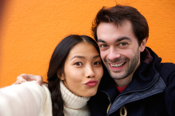 Happy young couple smiling and taking selfie