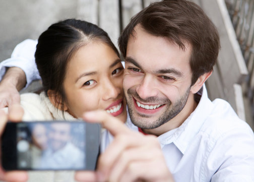 Happy young couple taking a selfie and smiling