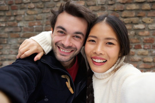 Happy smiling young couple taking selfie