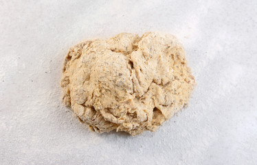 Rough ball of bread dough on a floured work surface
