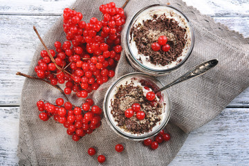 Delicious dessert in jars on table close-up