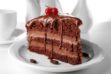 Delicious chocolate cake on plate on table on light background