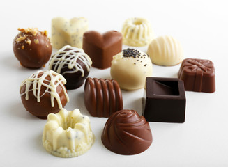 Delicious chocolate candies isolated on white