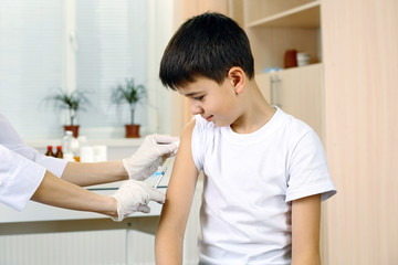 Fototapeta premium Boy and vaccine syringe