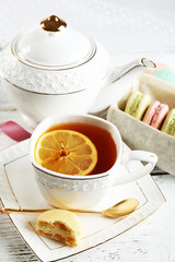 Colorful macaroons with cup of tea