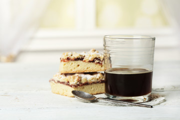 Glass of espresso and tasty homemade pie on wooden table