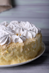 Tasty homemade meringue cake on wooden table