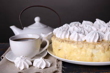 Tasty homemade meringue cake and cup of tea