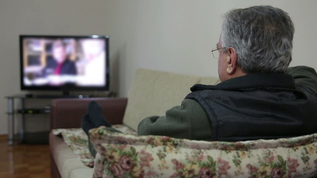 Senior man watching TV