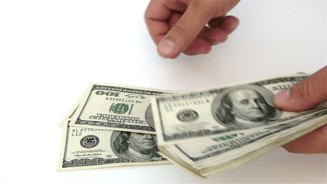 counting USD paper currency on white