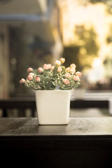 Artificial flowers on wood table