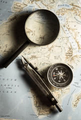 Compass with magnifier on map.