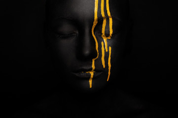 lady in black paint with yellow smudges