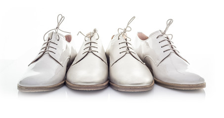 Four White Shoes on a White Background