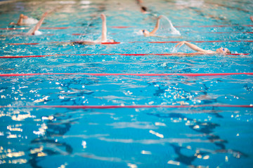 People swimming in indoor  swimming pool
