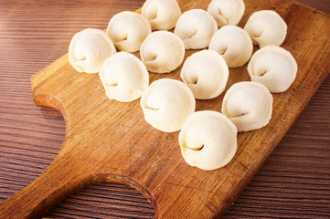 Homemade pasta ravioli over wooden table