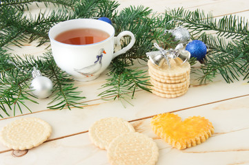 Obraz na płótnie Canvas Cookies on a wooden background with Christmas tree branches and