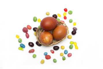 Happy Easter. Colored Easter eggs and candy. Photo.