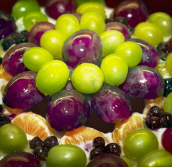 Fragment of a fruity cake with grapes in jelly with syrup