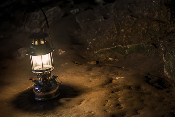 The old antique storm lantern in a cave © kikujungboy