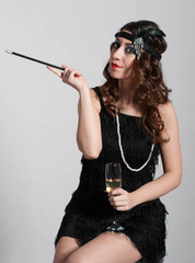 Young sexy girl posing in flapper style dress