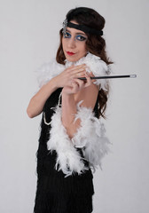 Young sexy girl posing in flapper style dress