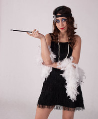 Young sexy girl posing in flapper style dress