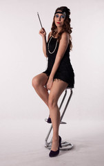 Young sexy girl posing in flapper style dress