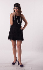 Young sexy girl posing in flapper style dress